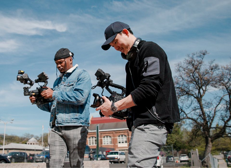 Two Cameramen Operating Handheld Cameras